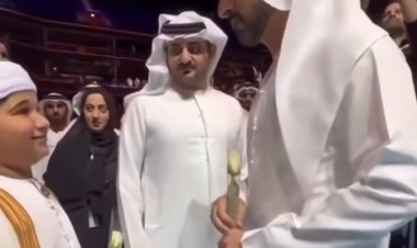 Sheikh Hamdan holding a white rose at the Arab Hope Makers ceremony