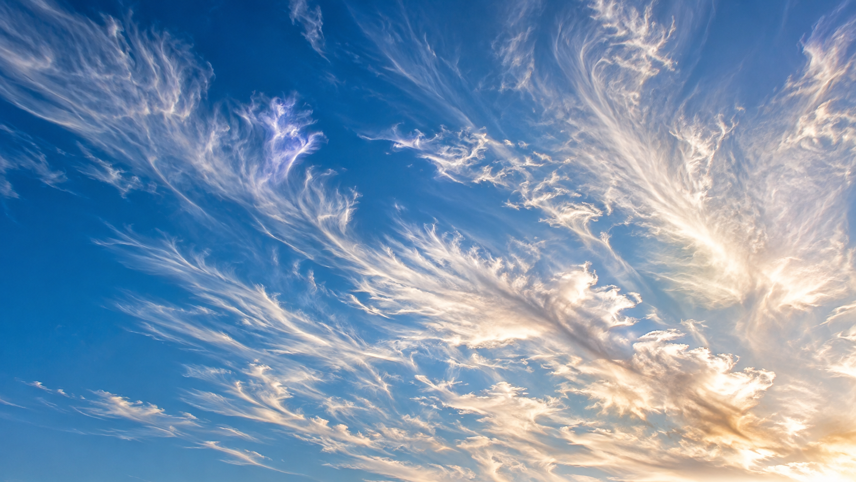 Thin wisps of cloud against a blue sky