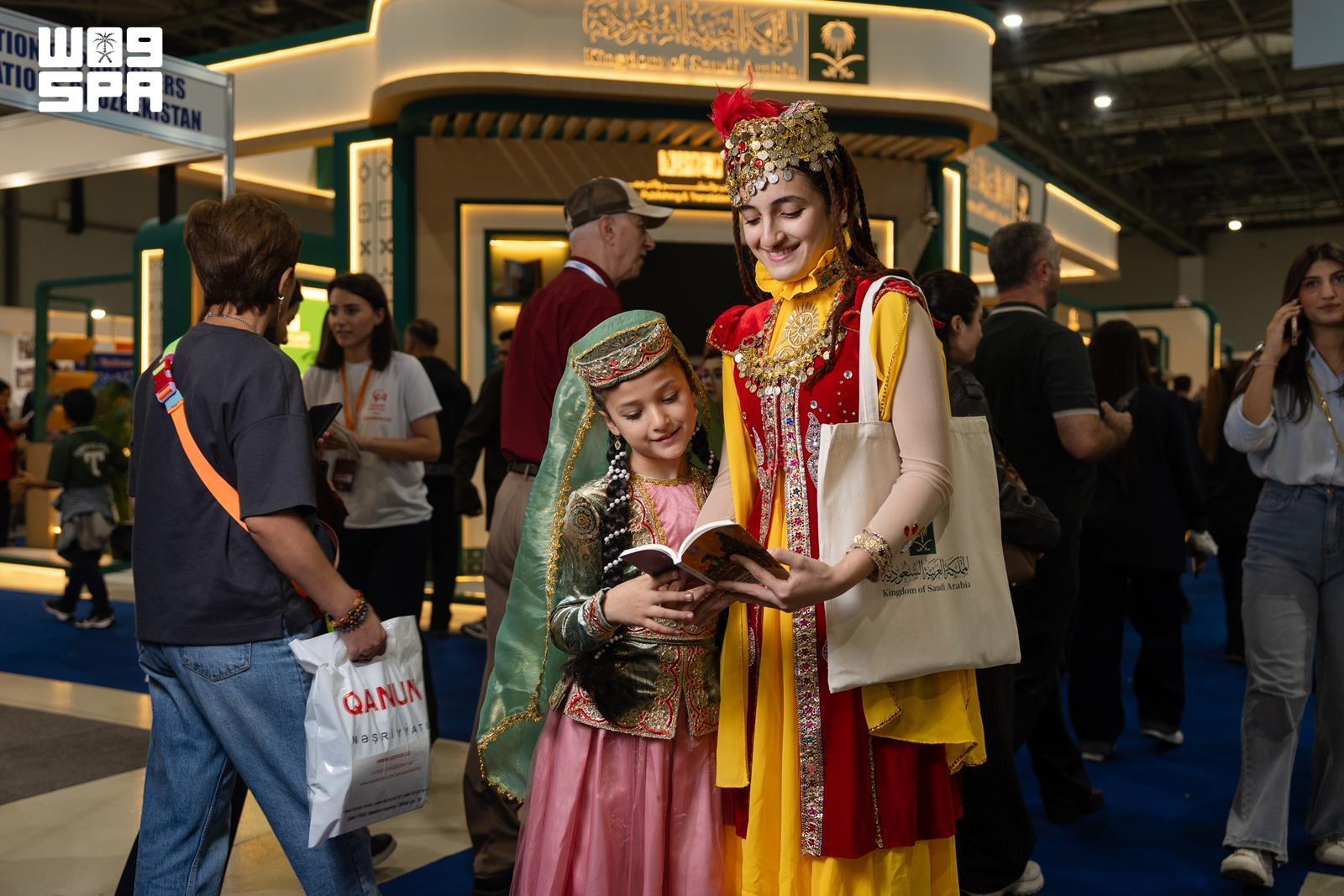Visitors reading at Saudi Arabia’s pavilion at Baku International Book Fair