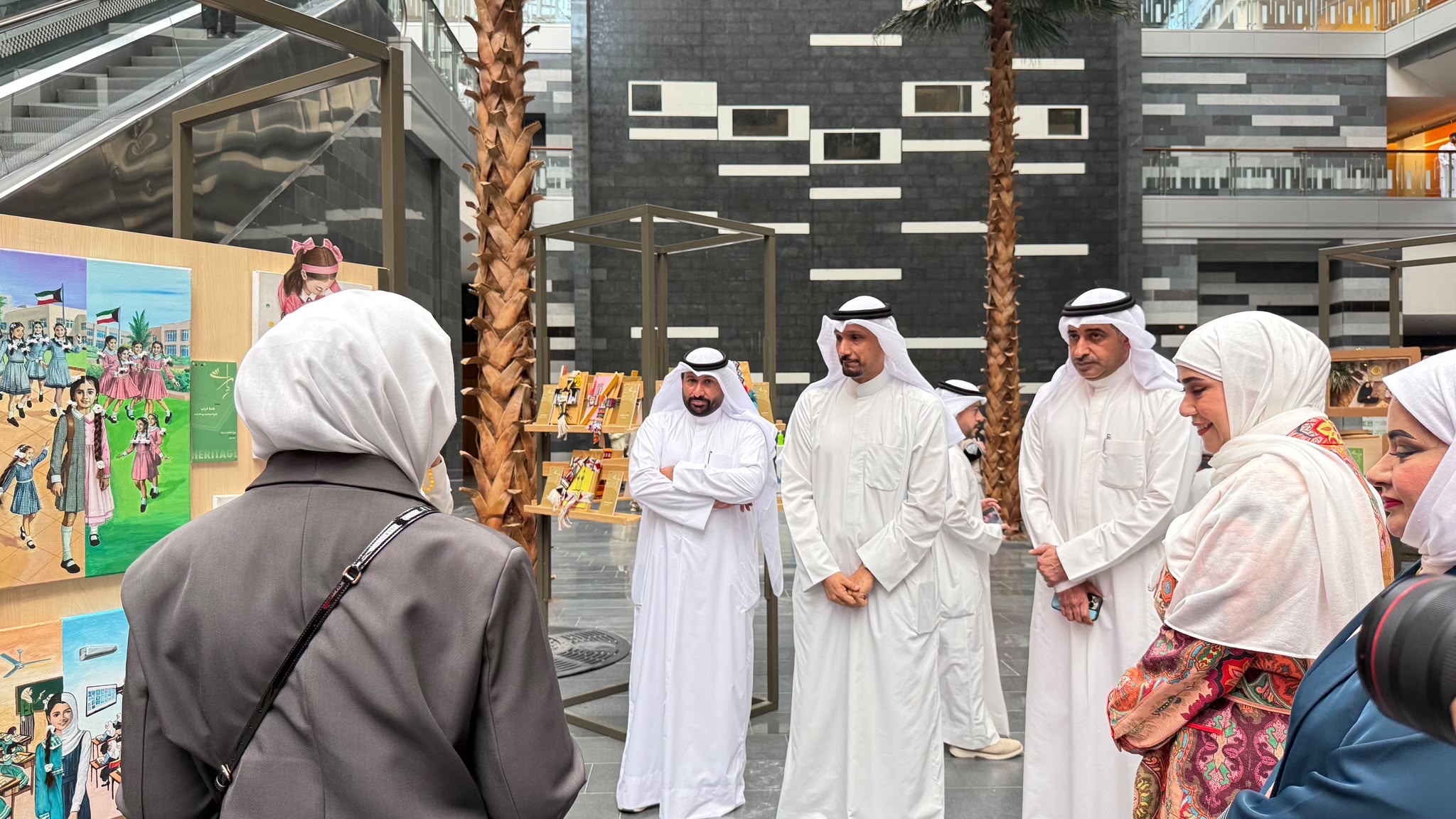 Visitors view artwork at the Irth education exhibition in Kuwait’s Ministry of Education lobby