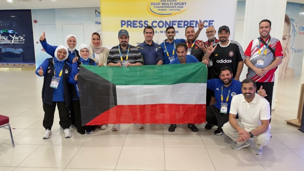 Kuwait’s deaf sports delegation holding the national flag at the event in Malaysia