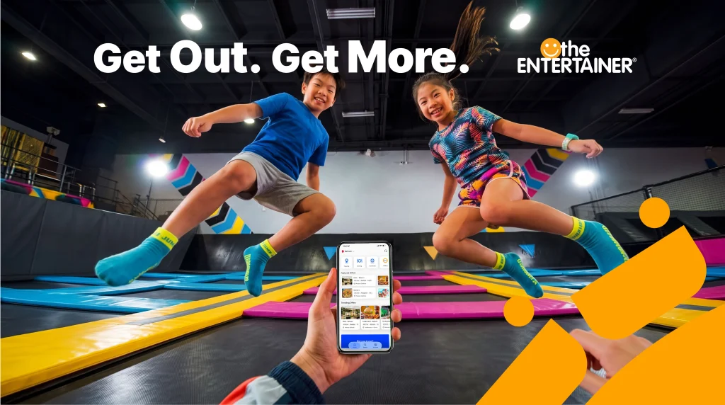 Children at a trampoline attraction in the ENTERTAINER Bahrain campaign artwork