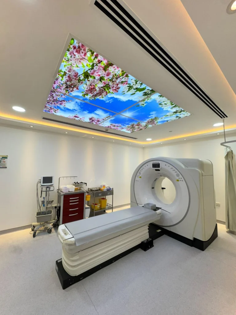 An imaging room at Al Hilal Premier Hospital with a ceiling display