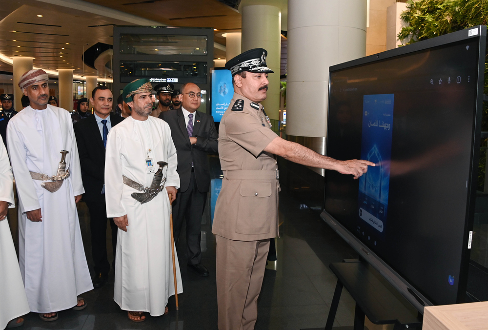 Officials view an information screen at the opening of the worker-rights awareness office at Muscat International Airport.