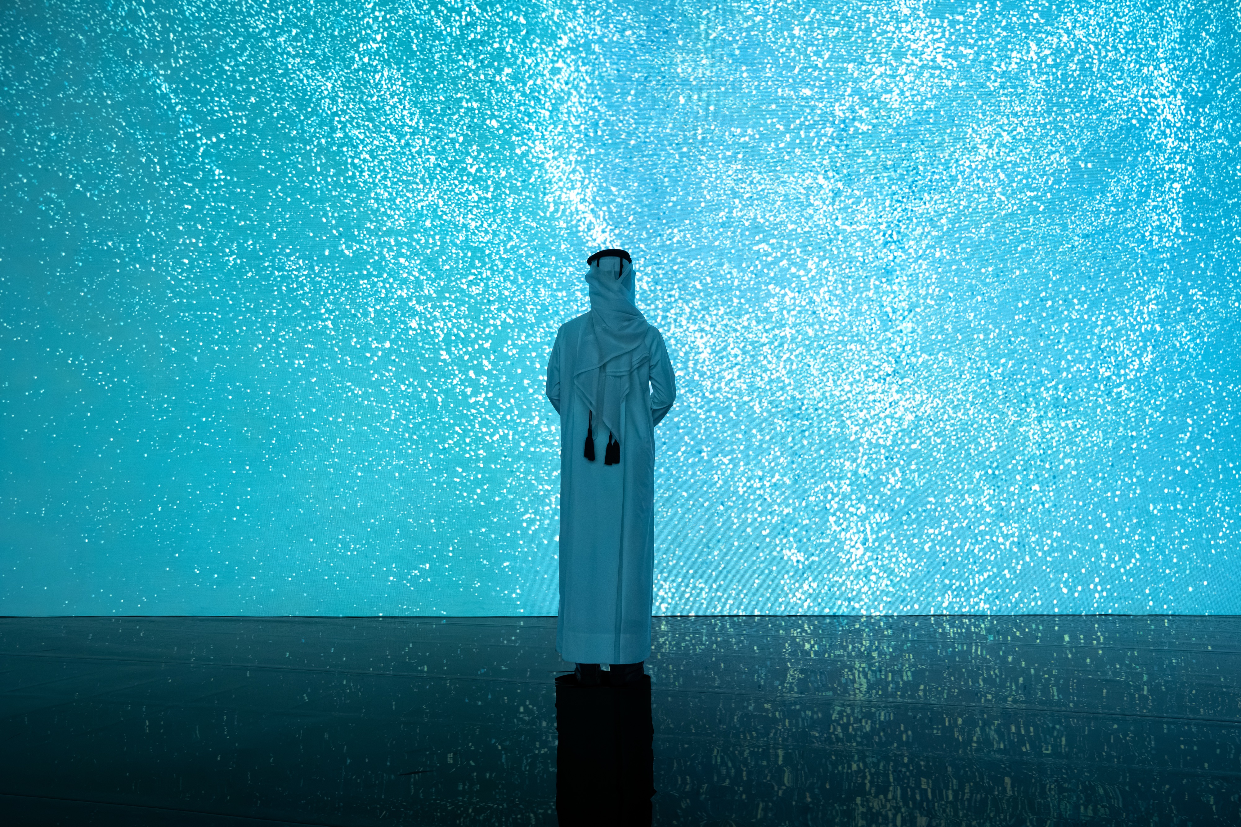A visitor in the All That Is Unseen exhibition at Media Majlis Museum