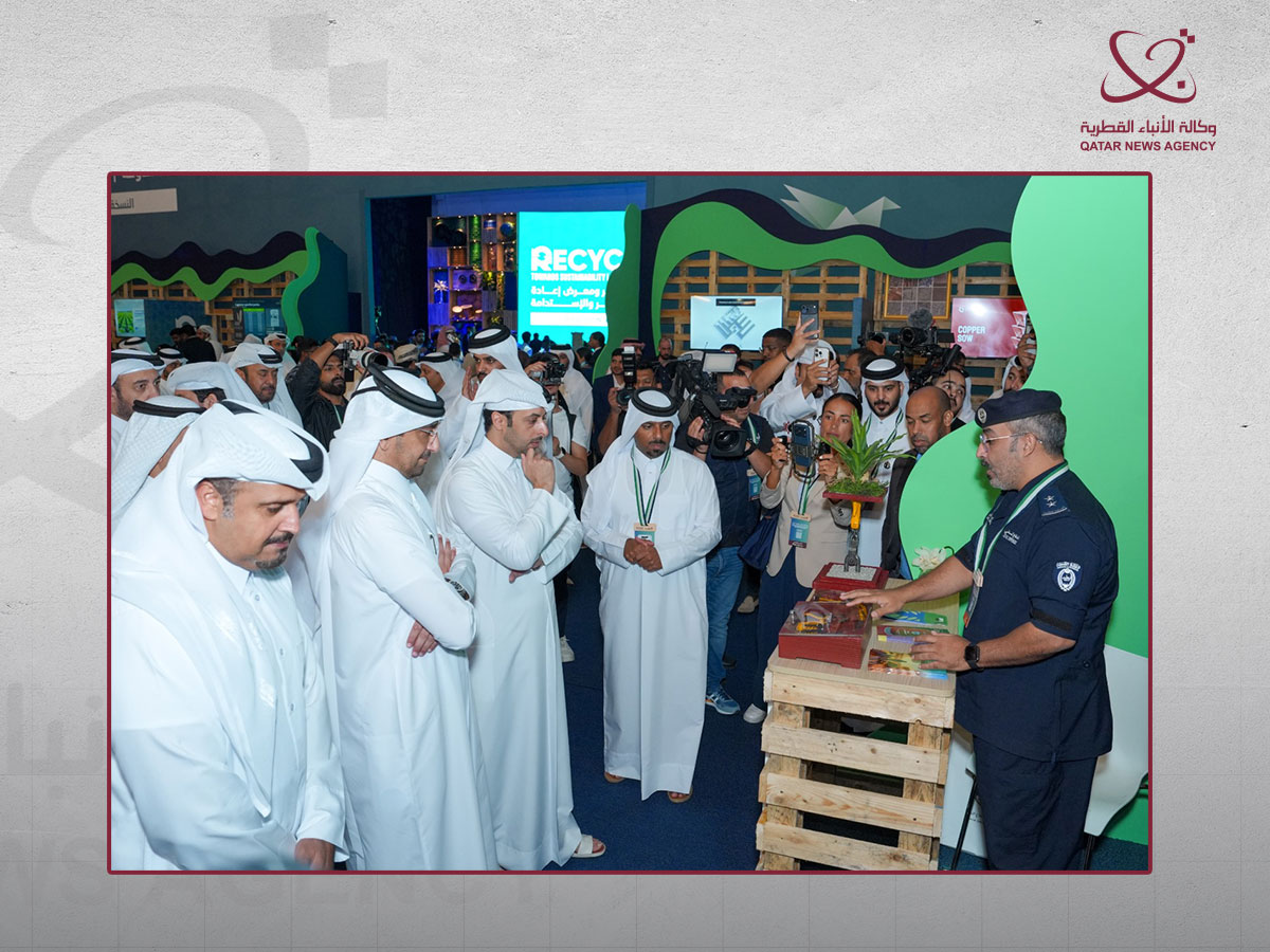 Officials visit a recycling exhibition stand in Qatar