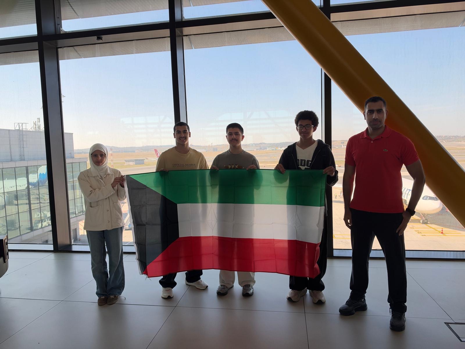 Kuwait delegation holding the national flag at the airport.